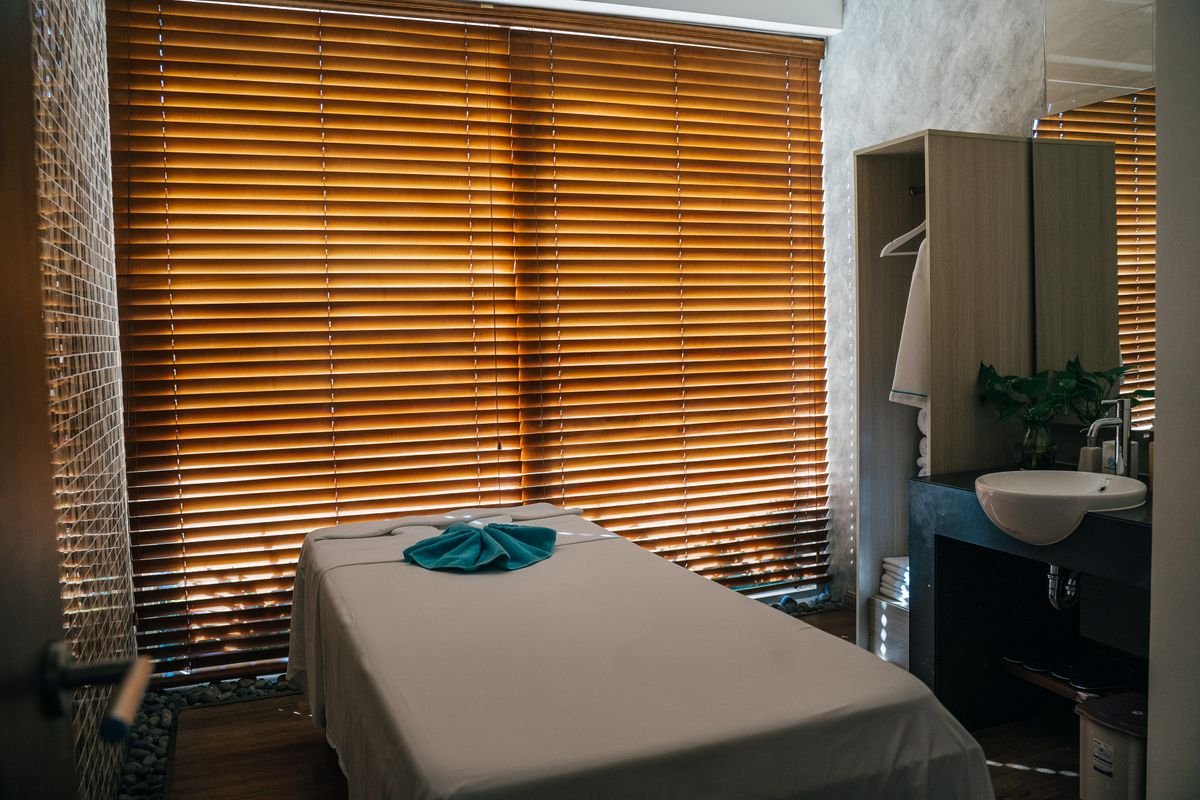 A treatment room at Elite Spa, backlit through wooden blinds